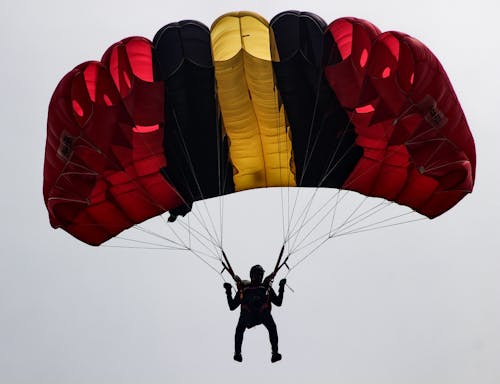 Free Person in Red and Blue Parachute on Air Stock Photo