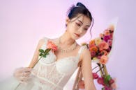 Elegant Woman in Bridal Dress Holding Rose