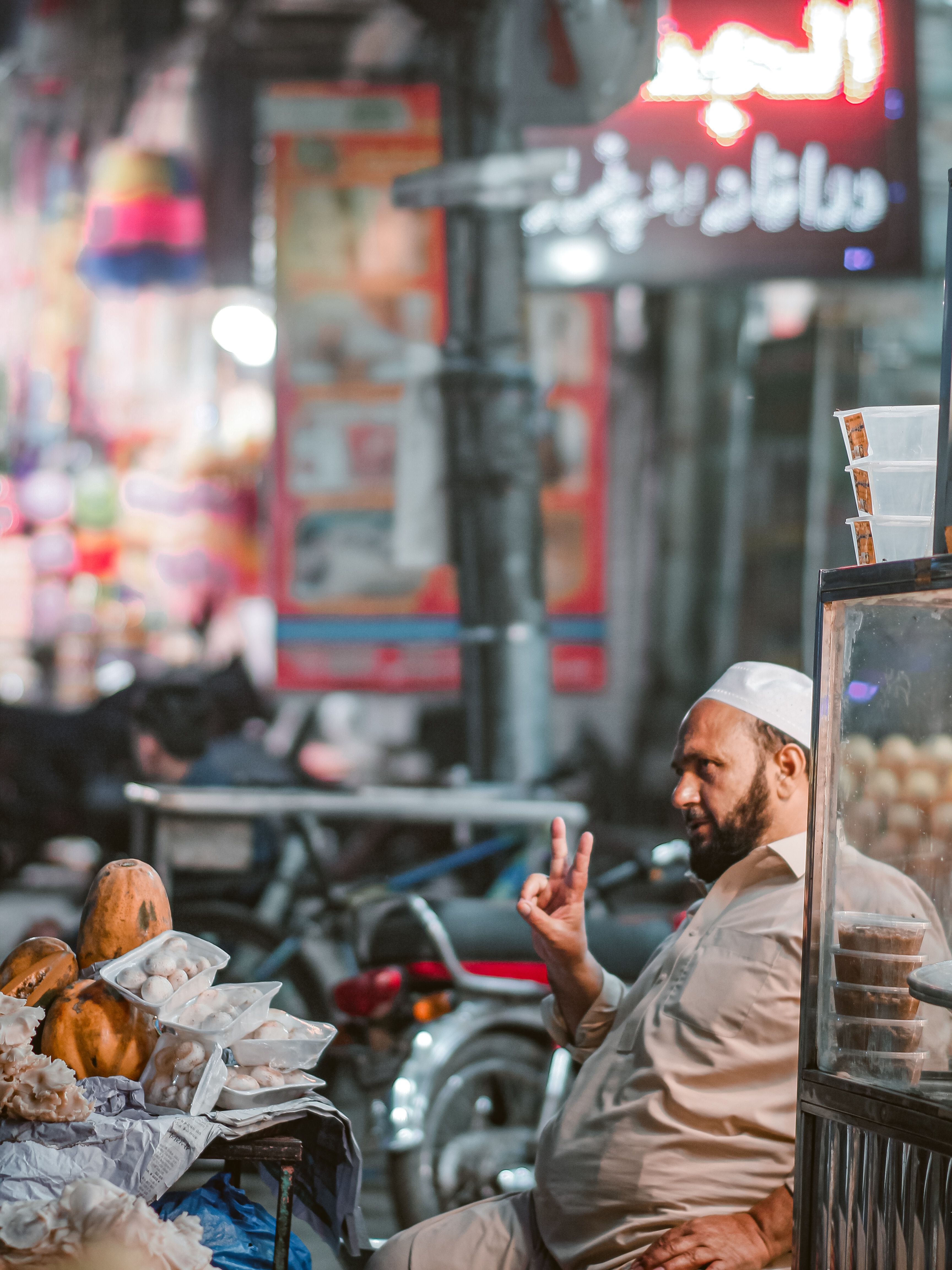 Lively market scene in Peshawar featuring a vendor with fresh produce and colorful lights. - Introduction