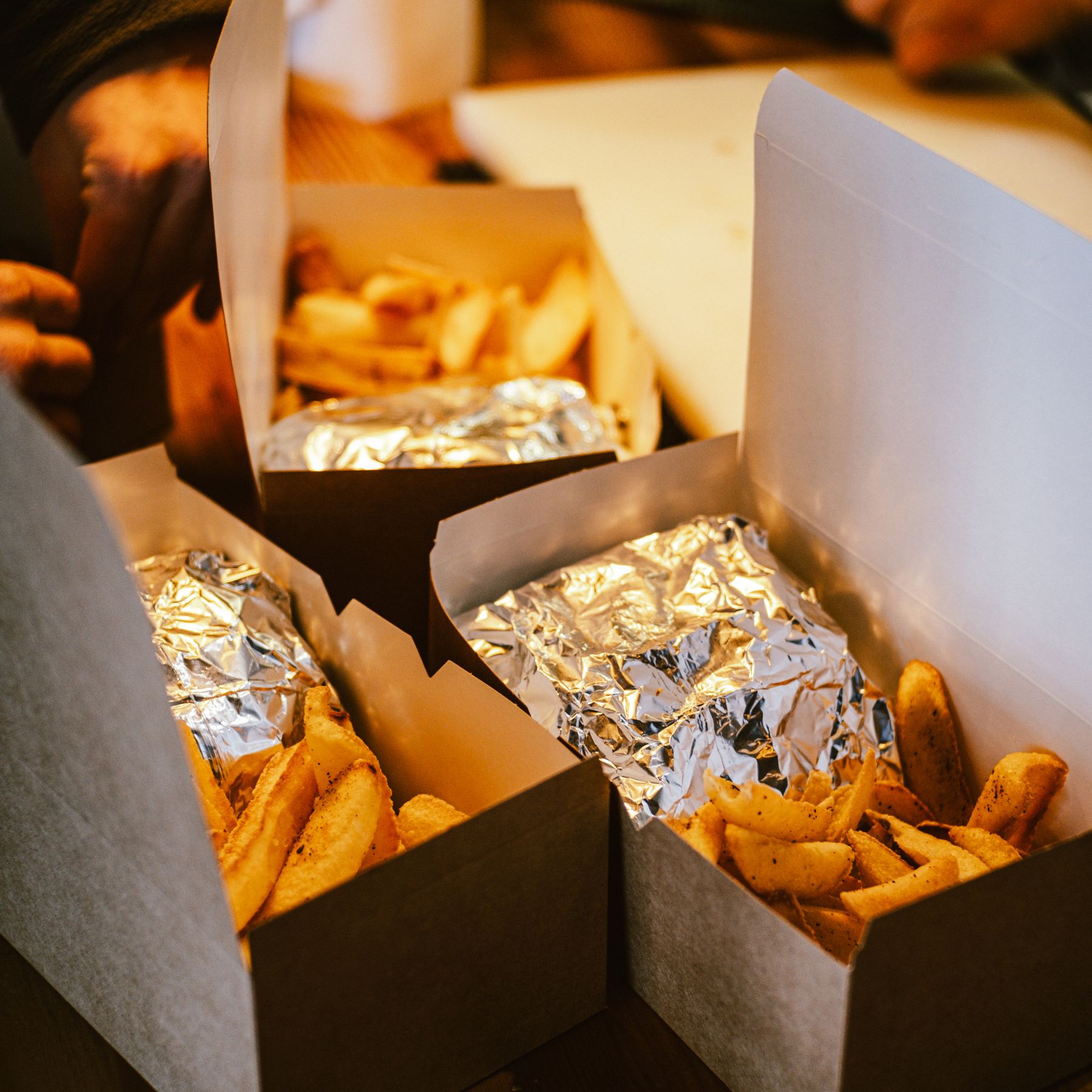 Warm takeout food in cardboard boxes ready to share