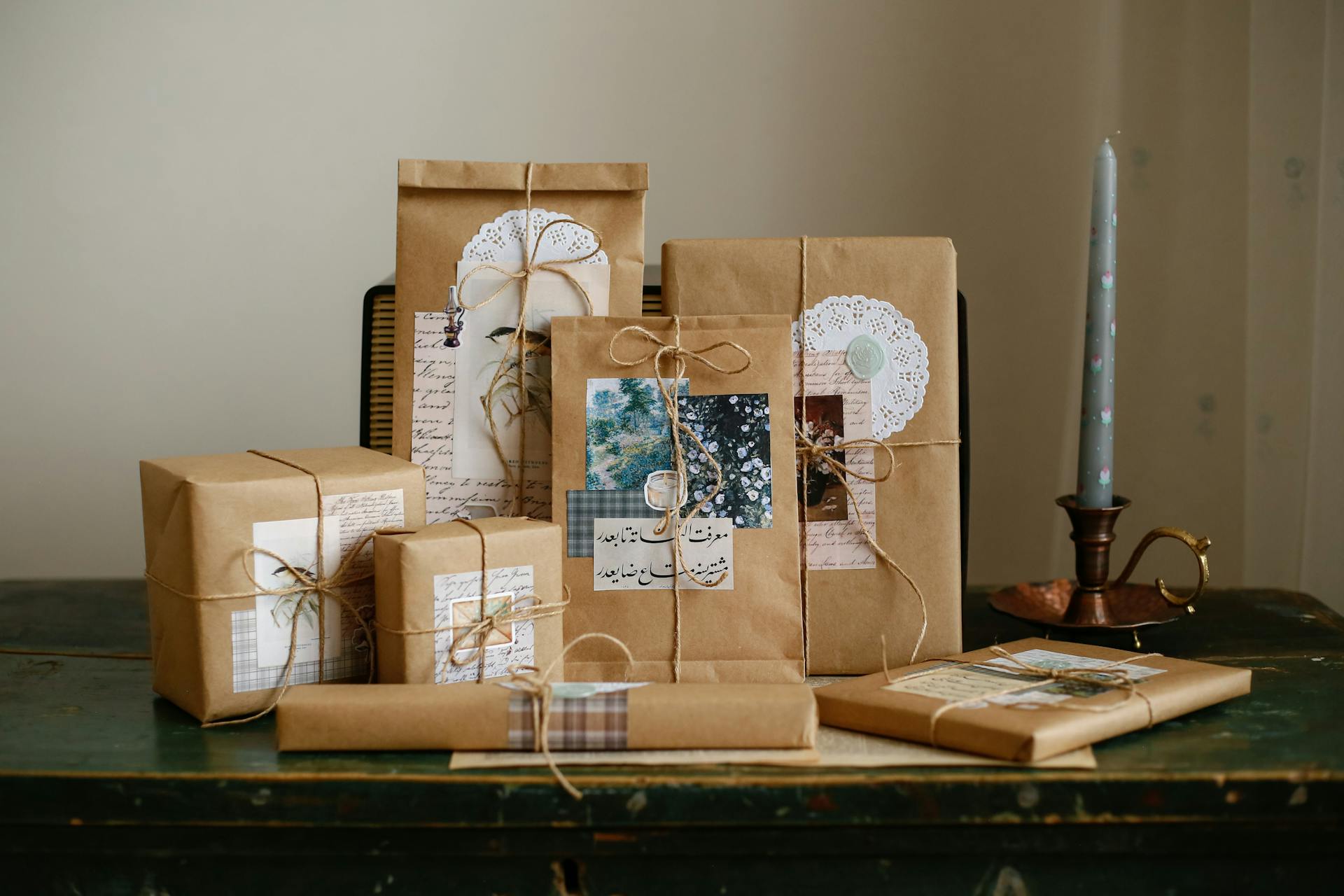 A collection of gifts wrapped in brown paper with twine and vintage decorations.