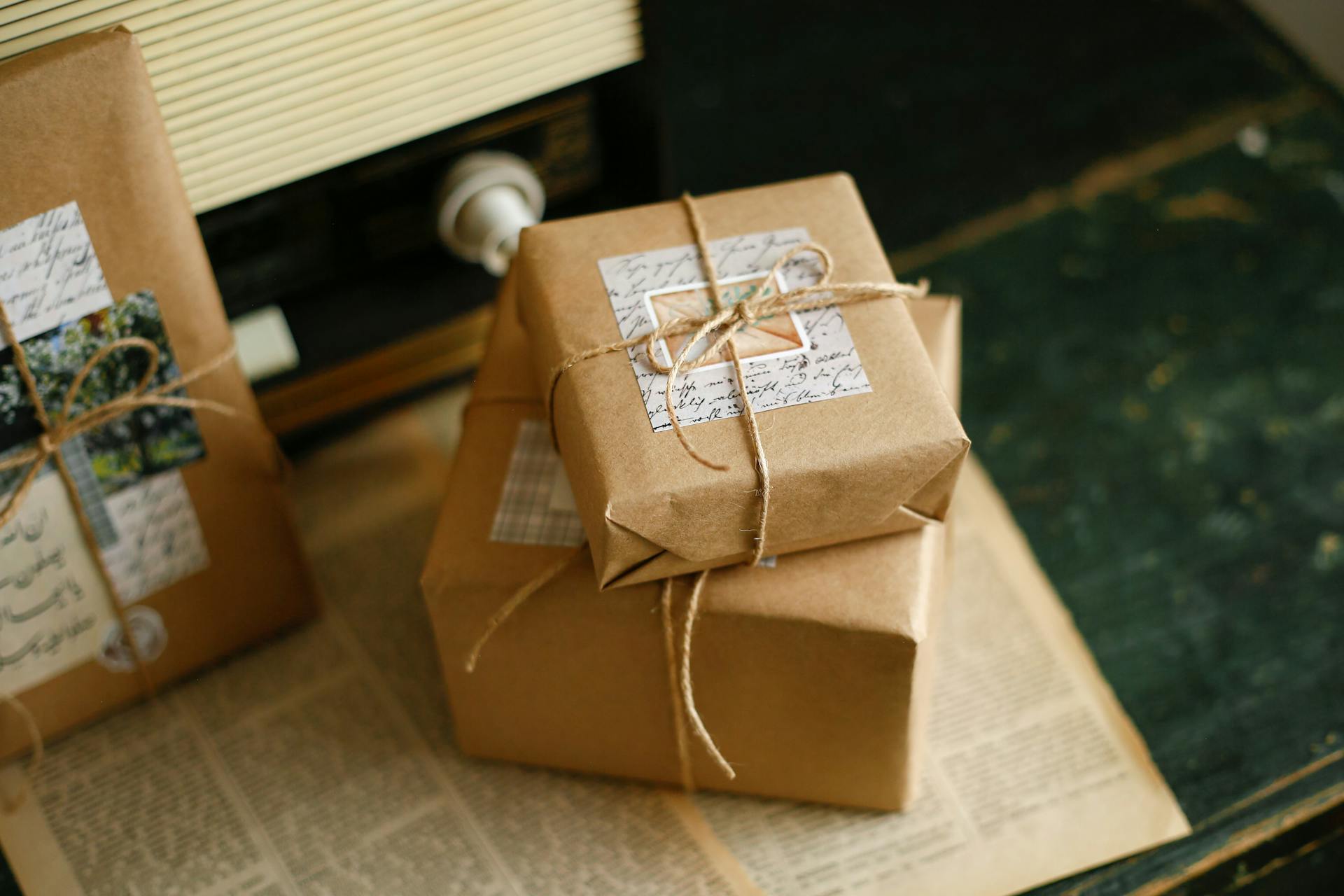 Beautifully wrapped vintage style gifts with twine and personalized tags, perfect for special occasions.