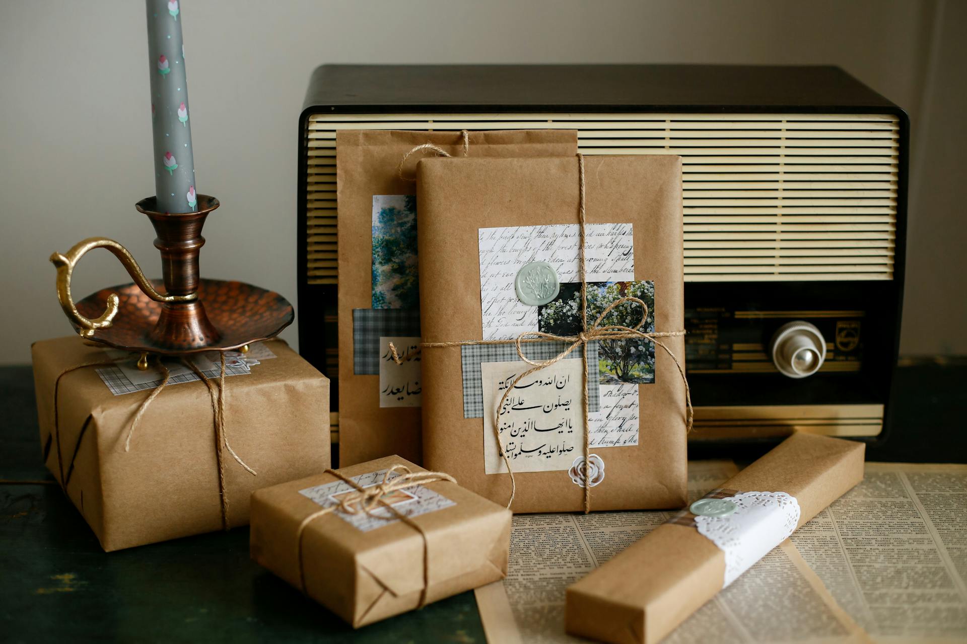 Charming vintage-style gifts with kraft paper, retro radio, and elegant candlestick, perfect for nostalgic decor.