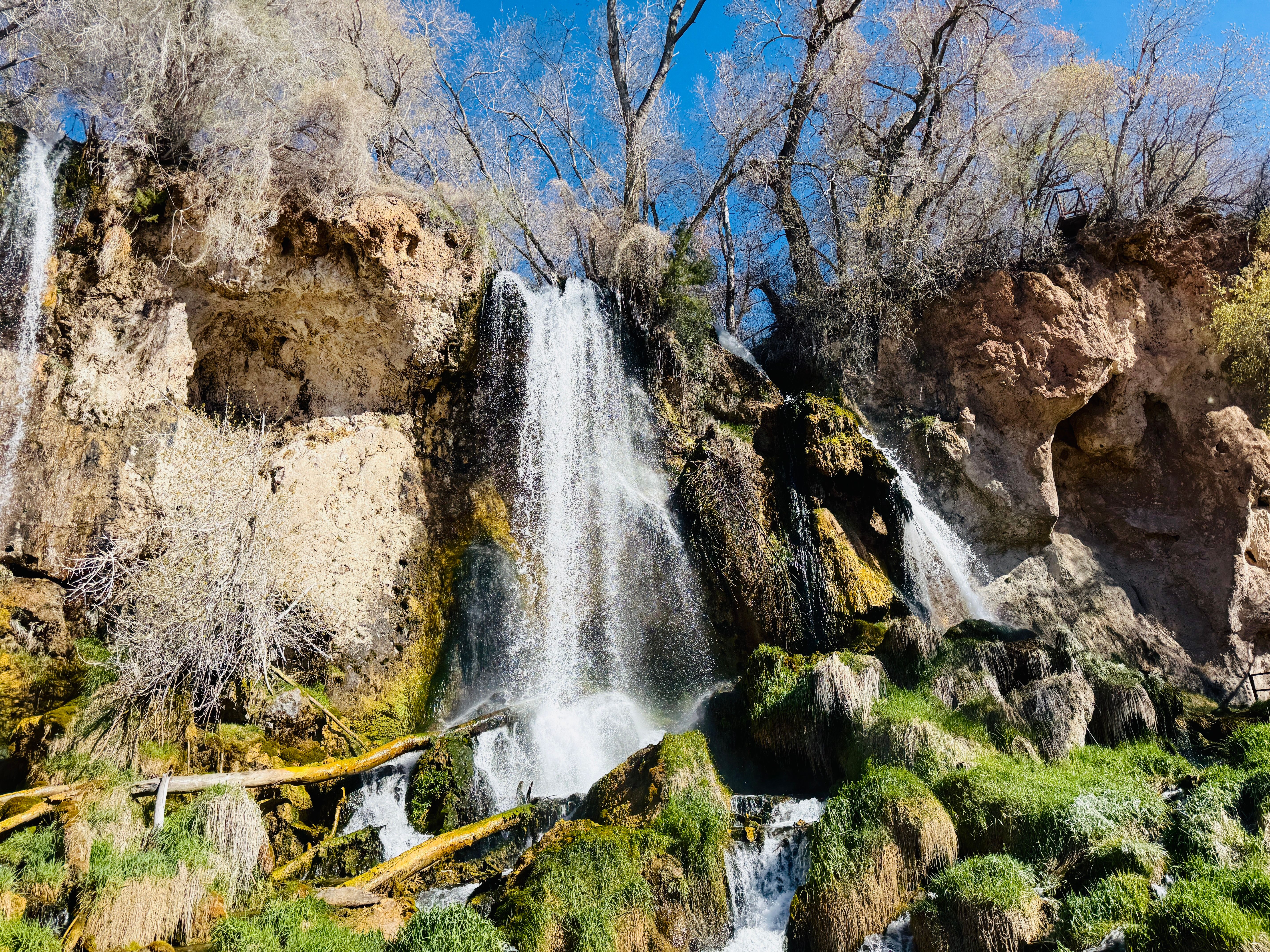Scenic waterfall in Glenwood Springs, Colorado with lush greenery.