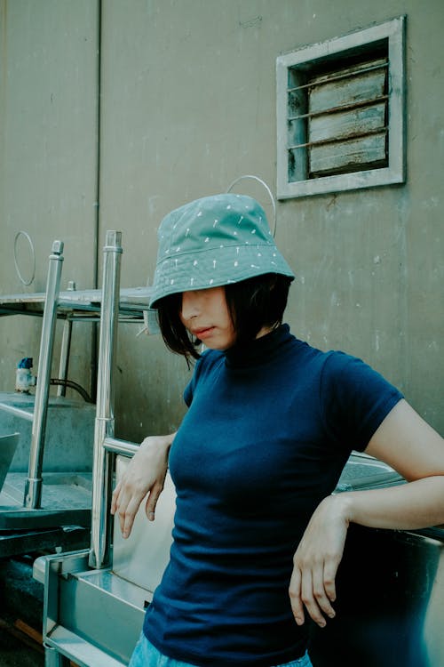 Standing Woman Wearing Gray Bucket Hat and Black Shirt