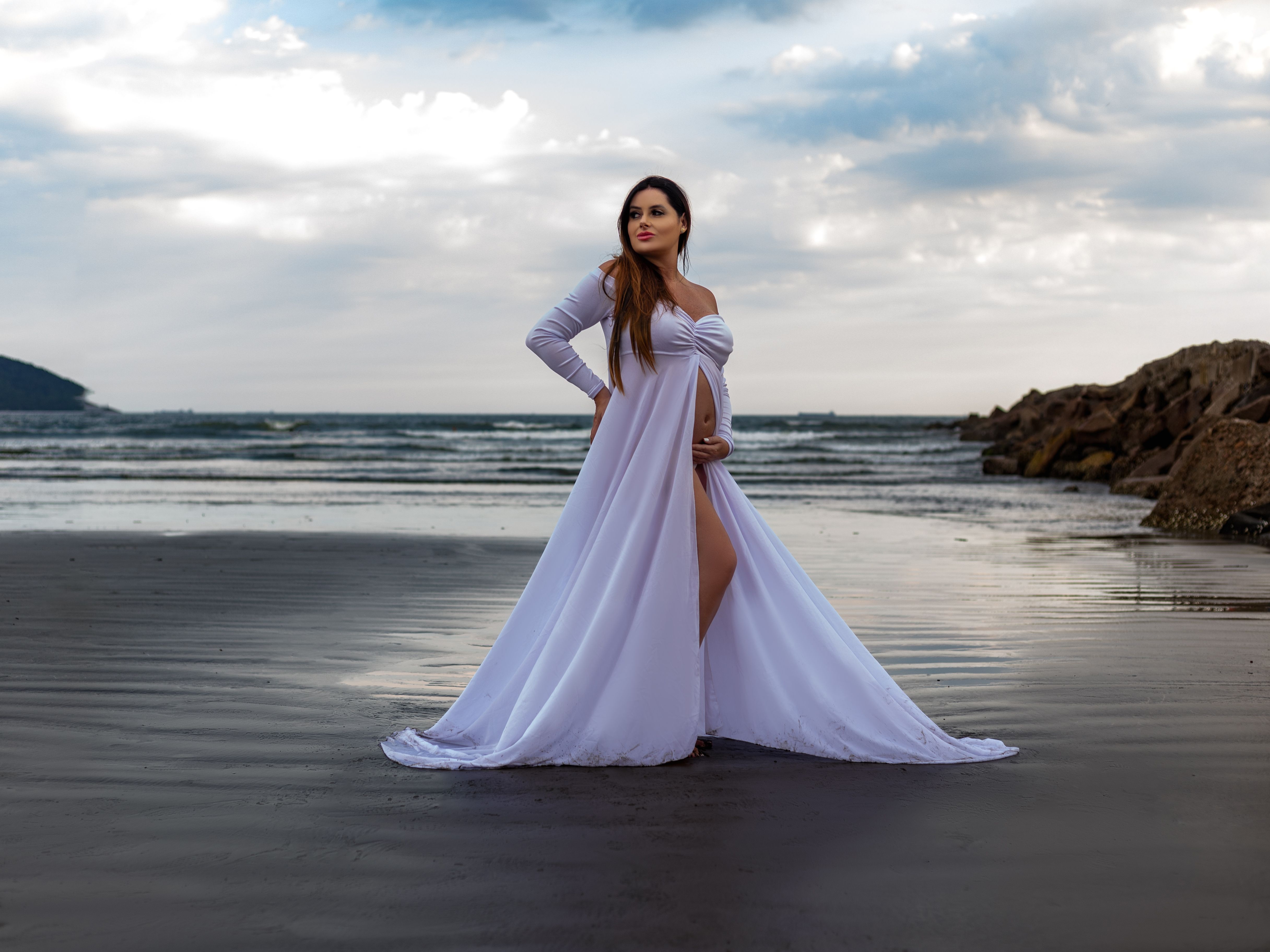 Elegant Maternity Photoshoot at a Scenic Beach  Free Stock Photo