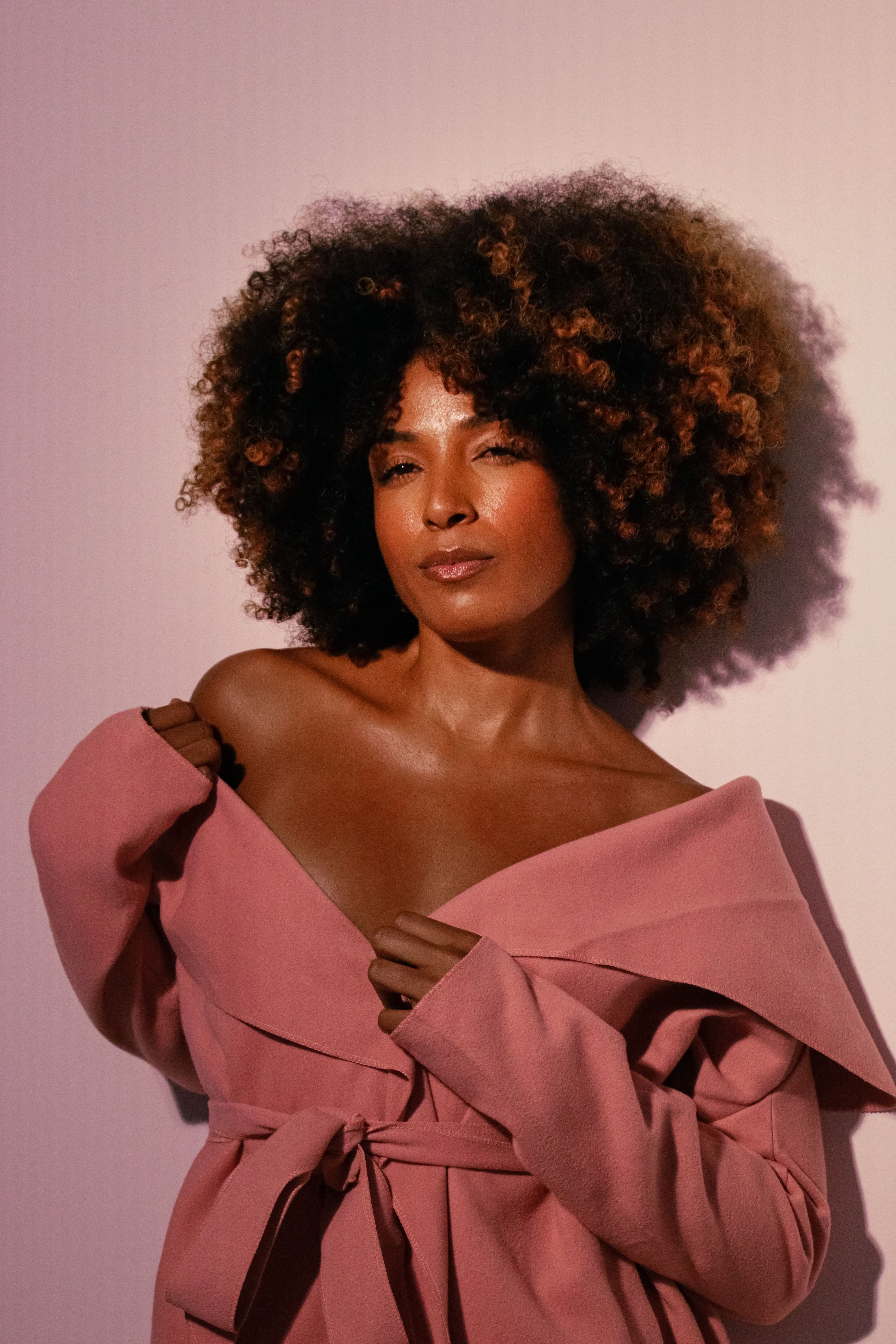 Stylish portrait of a woman wearing pink, showcasing elegance and confidence.
