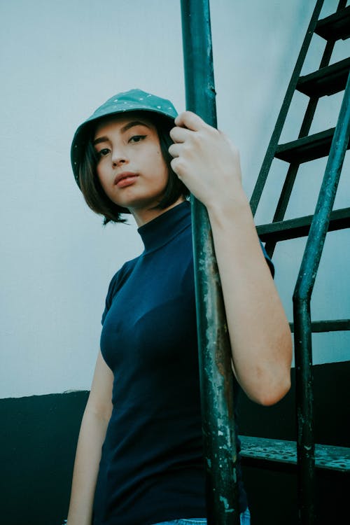 Shallow Focus Photo of Woman in Black Turtleneck Shirt Wearing Bucket Hat