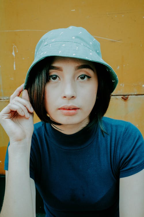 Free Shallow Focus Photo of Woman Wearing Gray Bucket Hat Stock Photo