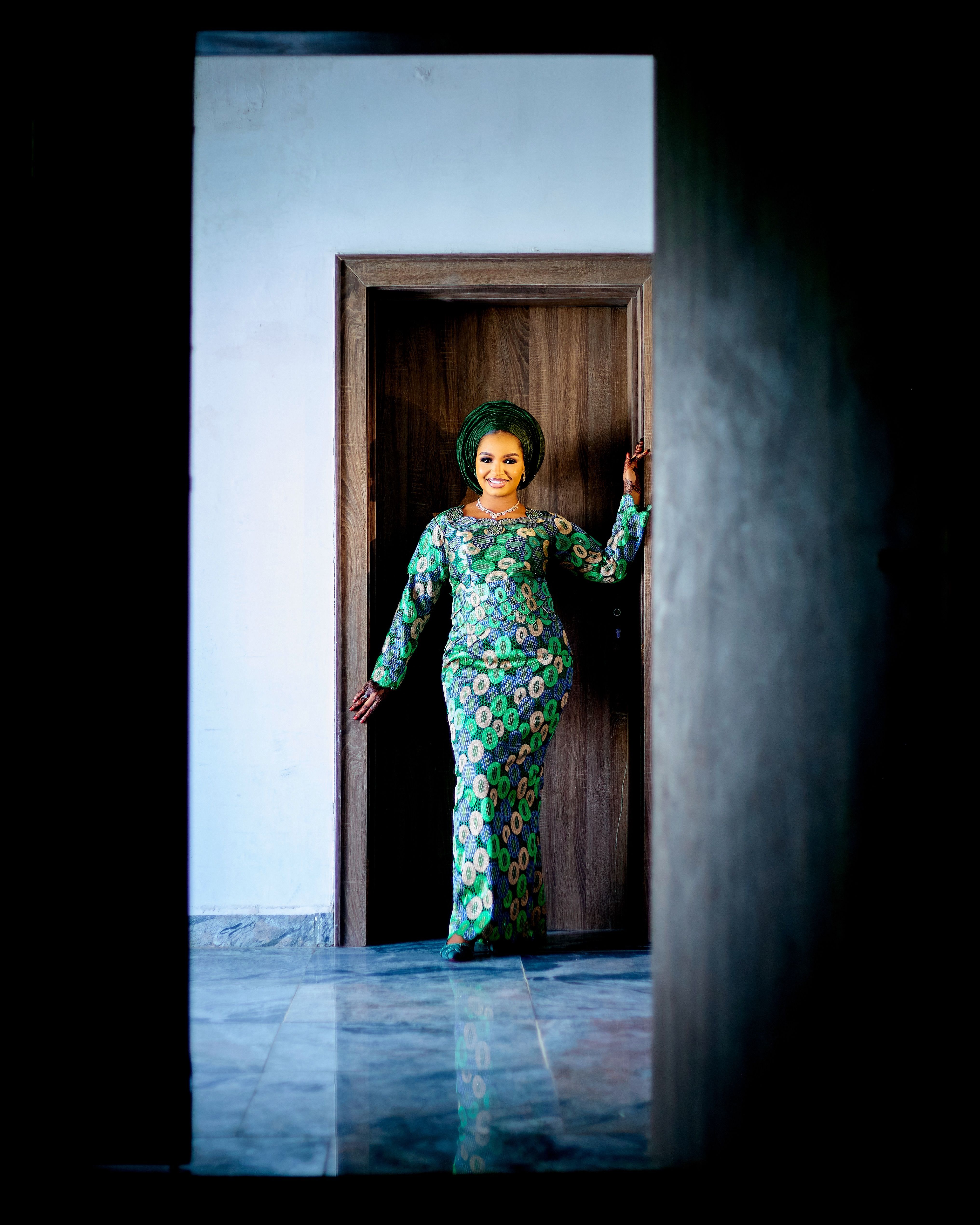 Elegant Woman in Traditional Attire by Doorway · Free Stock Photo