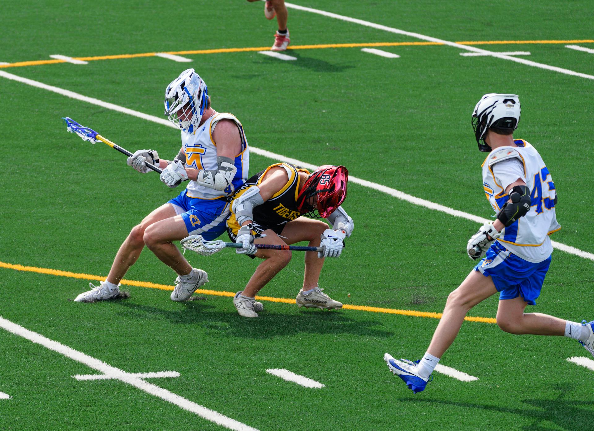 Dynamic action shot of a high school lacrosse game capturing athletes in intense competition.