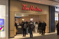 Busy Tim Hortons with customers waiting in line at the counter.
