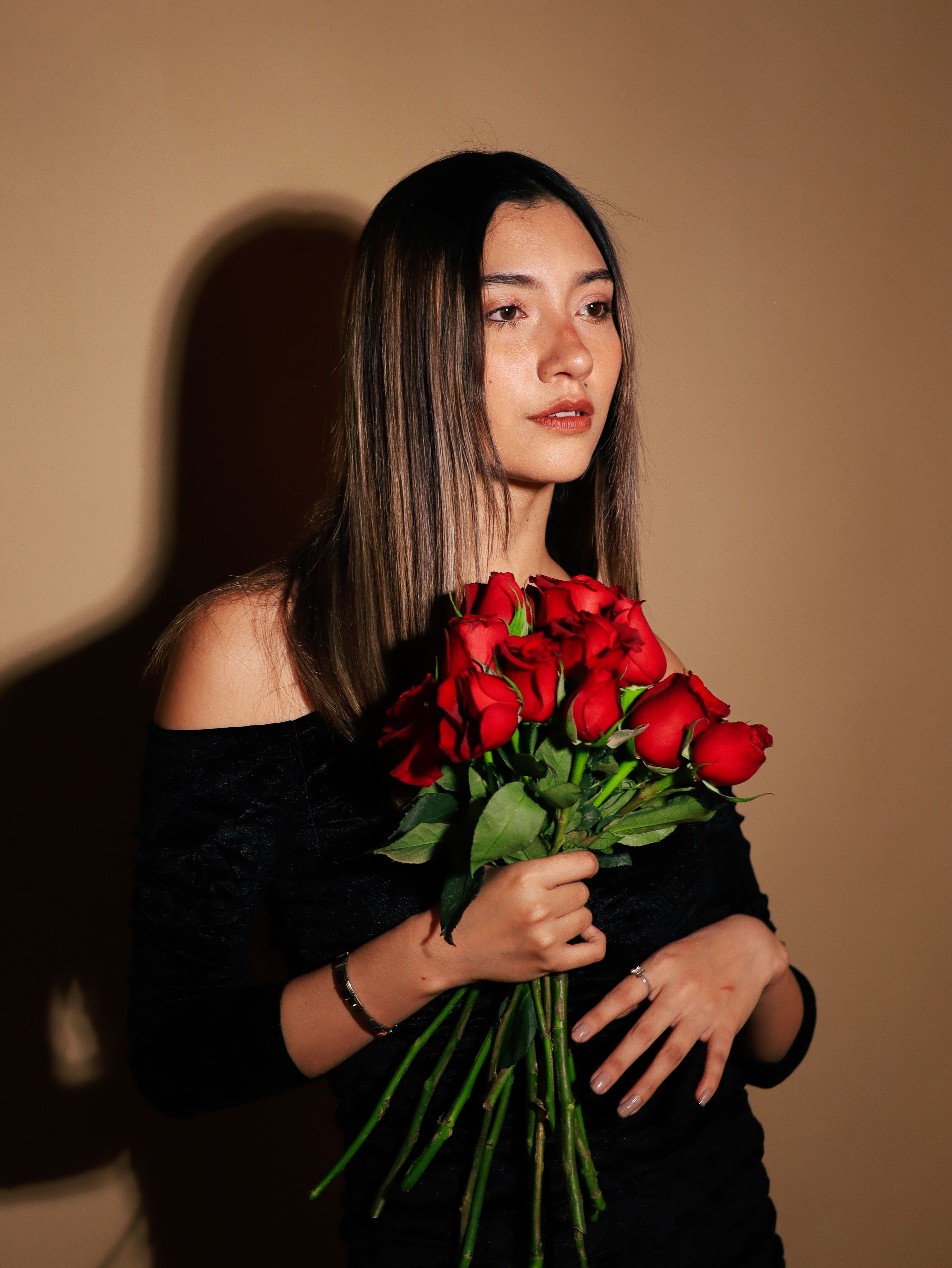 Elegant Woman Holding Red Roses Portrait · Free Stock Photo