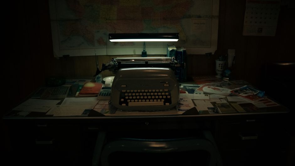How State Farm Bundle Discount Works for Combining Home and Auto Insurance A classic office scene with a vintage typewriter on a cluttered desk under soft lighting.