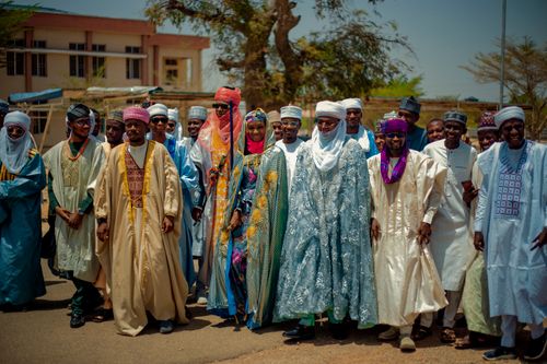 Free Group photo of adults in colorful traditional attire at a cultural celebration. Stock Photo