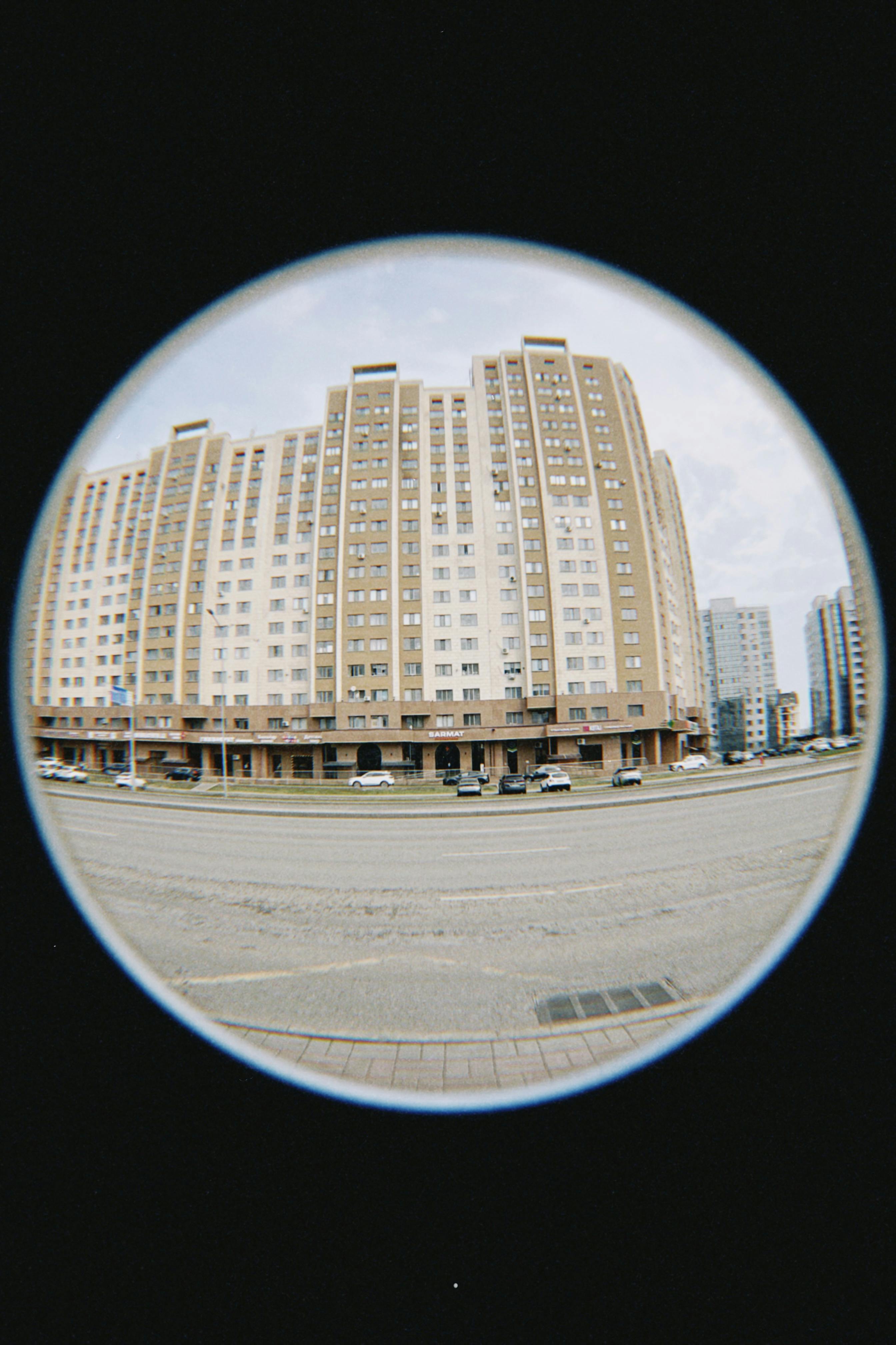 Fisheye lens capturing high-rise residential buildings in Astana, Kazakhstan.