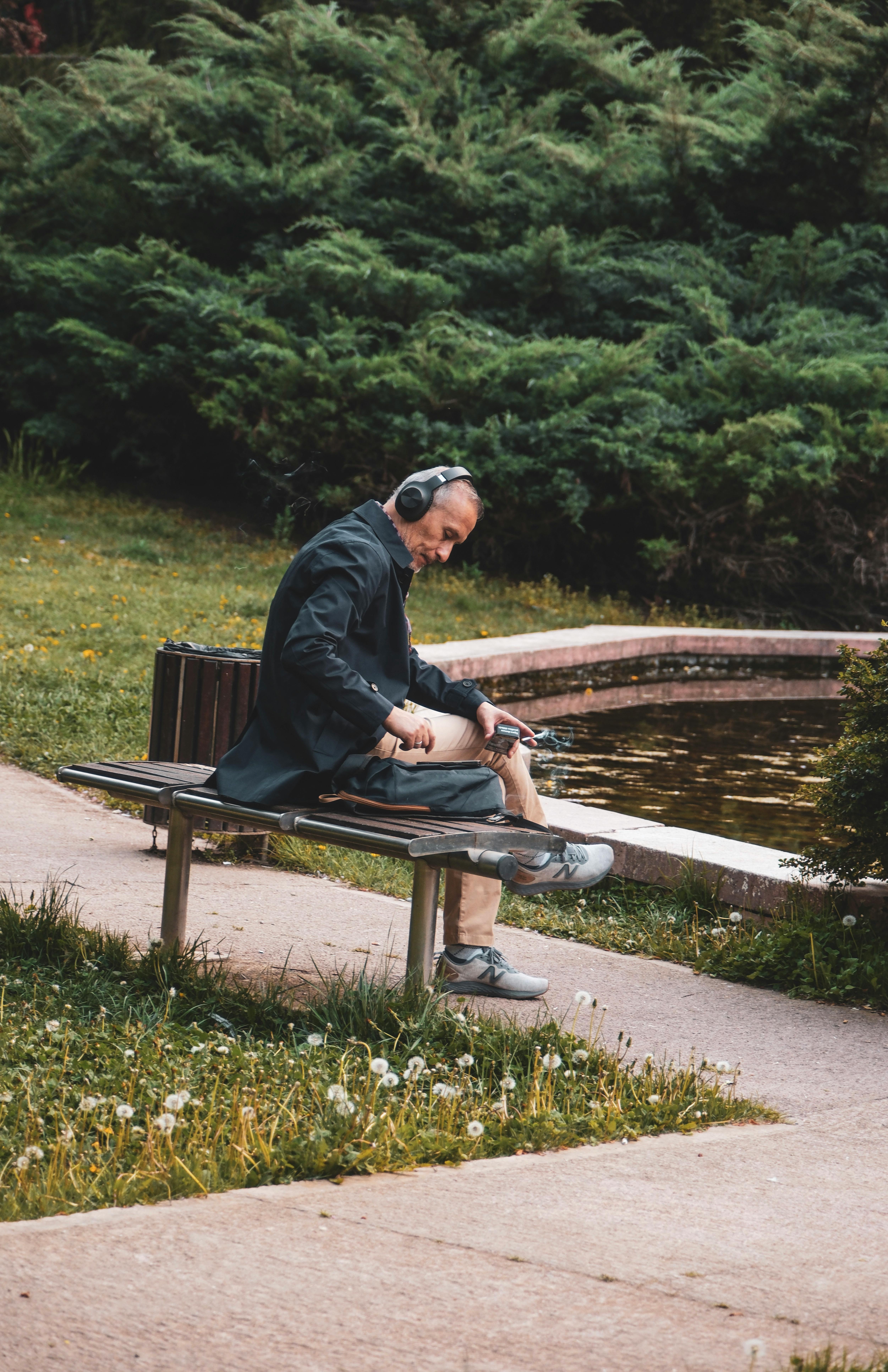 why does music evoke emotion — man with headphones in a quiet park