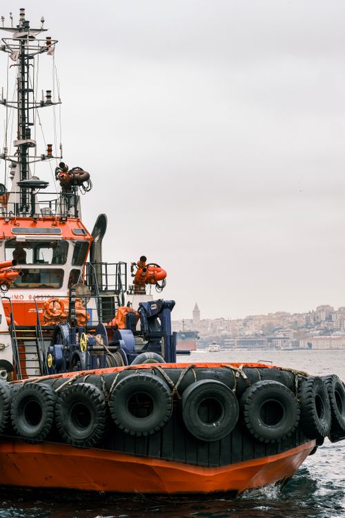 Free An orange coast guard ship navigates the Bosphorus with a backdrop of Istanbul's skyline. Stock Photo