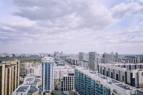 Free Aerial view of Astana's modern skyline under a partly cloudy sky. Stock Photo