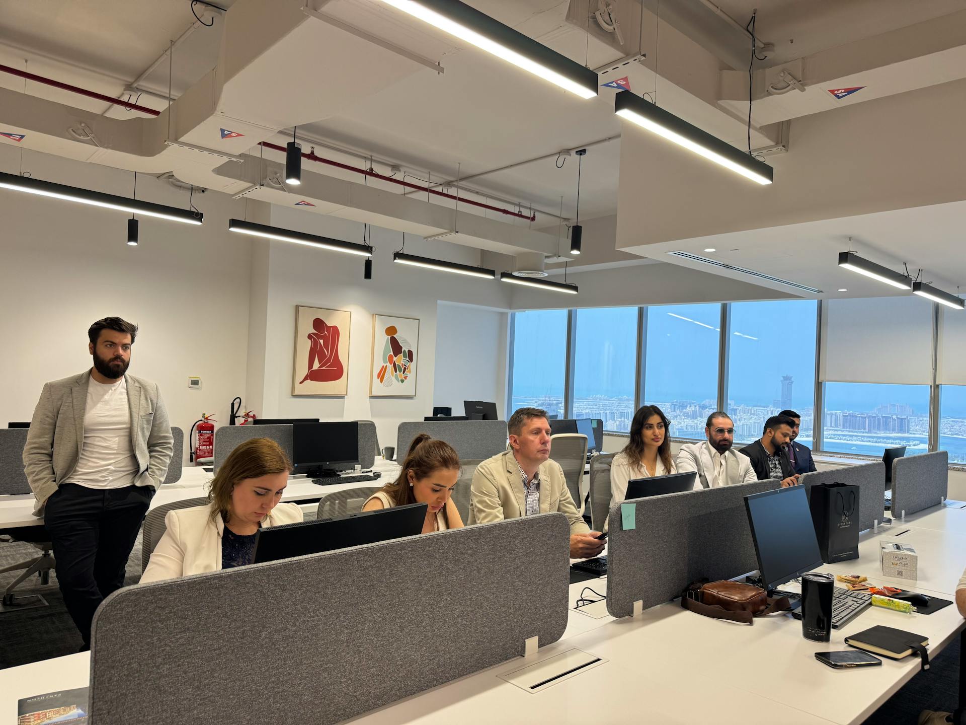 Diverse team in a modern office setting focusing on a business meeting.