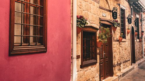 Free Charming historic street in Antalya with vibrant architecture and potted plants. Stock Photo