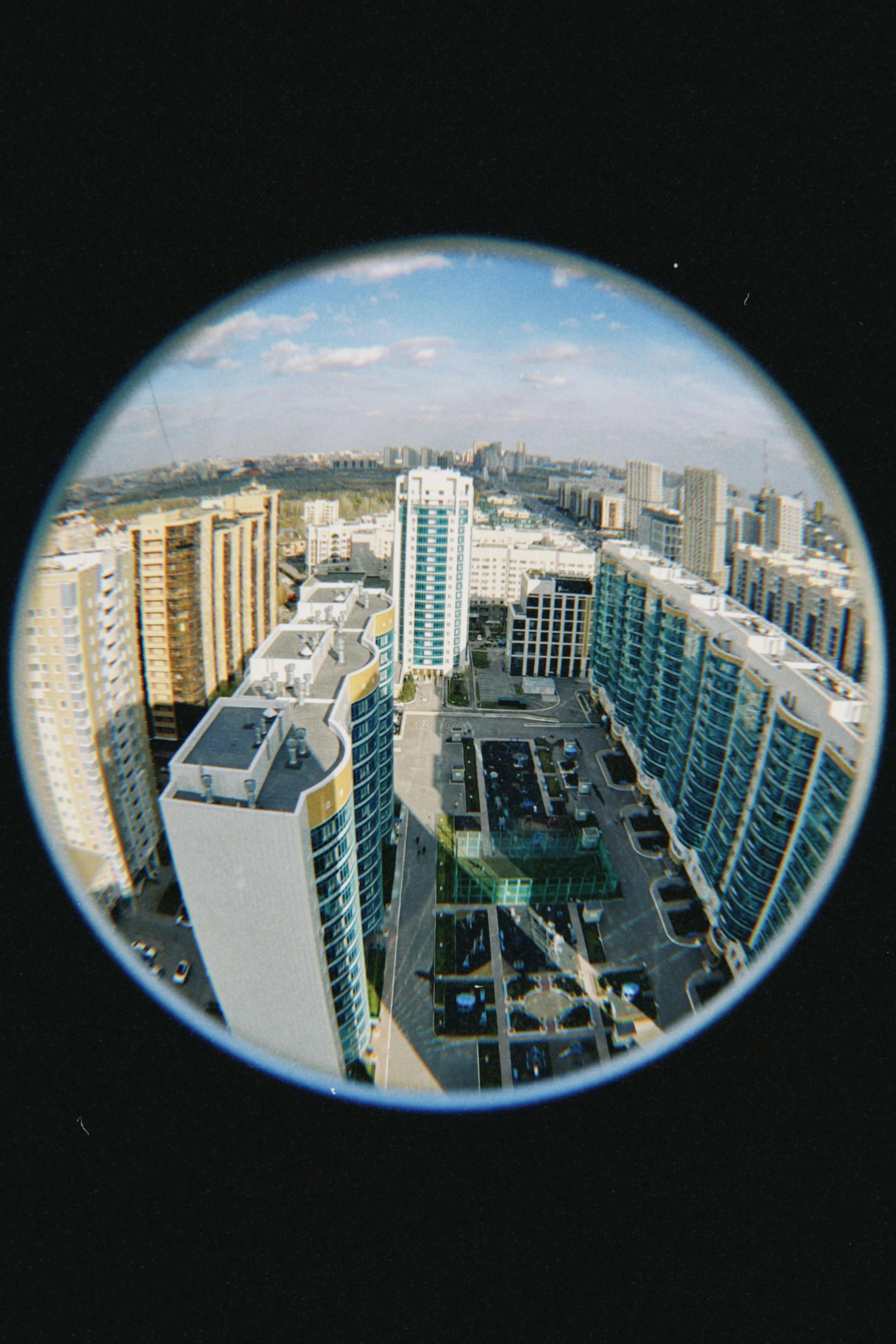 Explore the stunning architecture of Astana with this aerial fisheye view of modern skyscrapers.