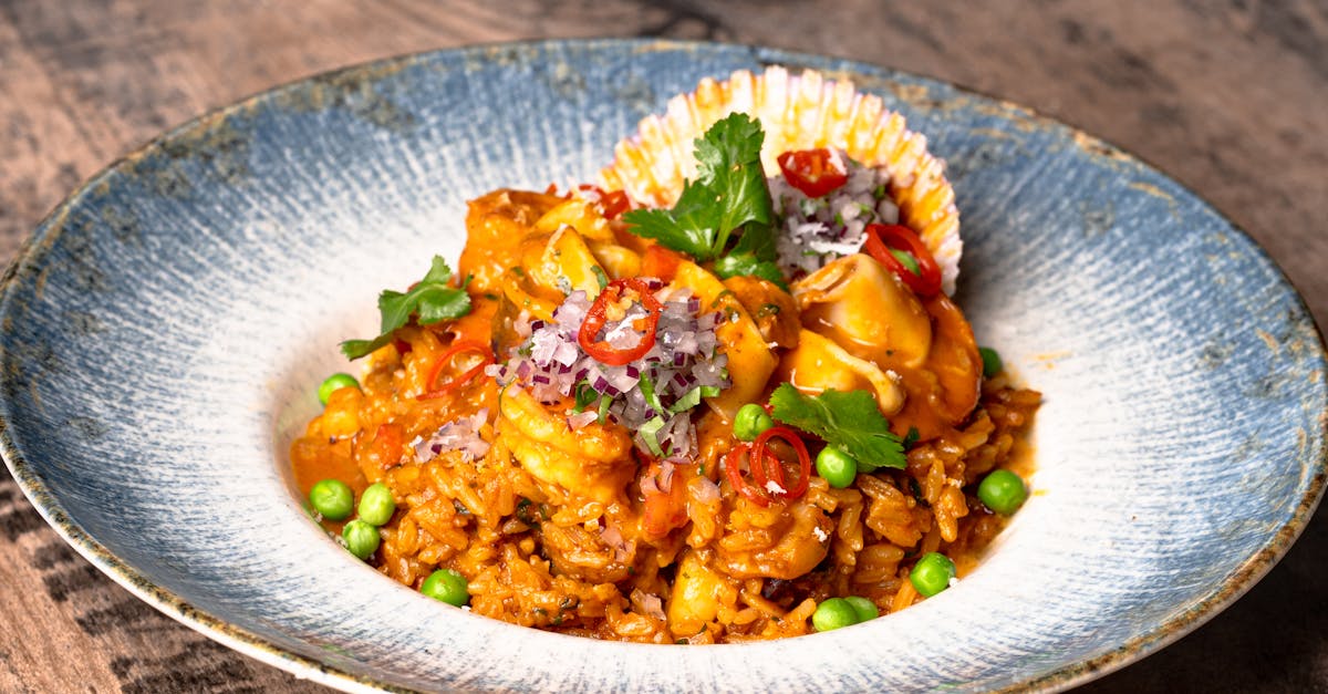A colorful plate of paella with seafood, a traditional Spanish dish.
