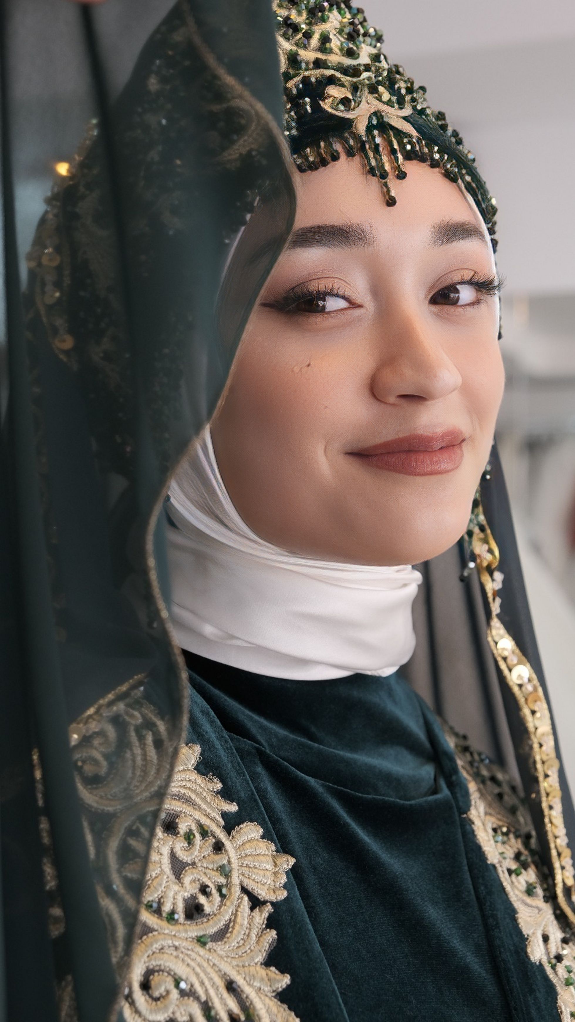 Elegant portrait of a woman wearing ornate traditional clothing. Timeless beauty and cultural expression.