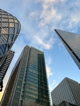 Modern skyscrapers in La Défense, Paris against a blue sky.