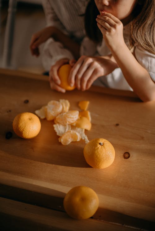 Free Girl Eating Orange Fruits Stock Photo