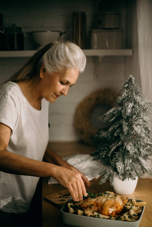 Selective Focus Photography of Standing Woman in Front of Dish