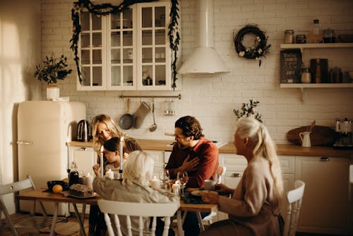 Free Family Sits on Table Inside Kitchen Stock Photo