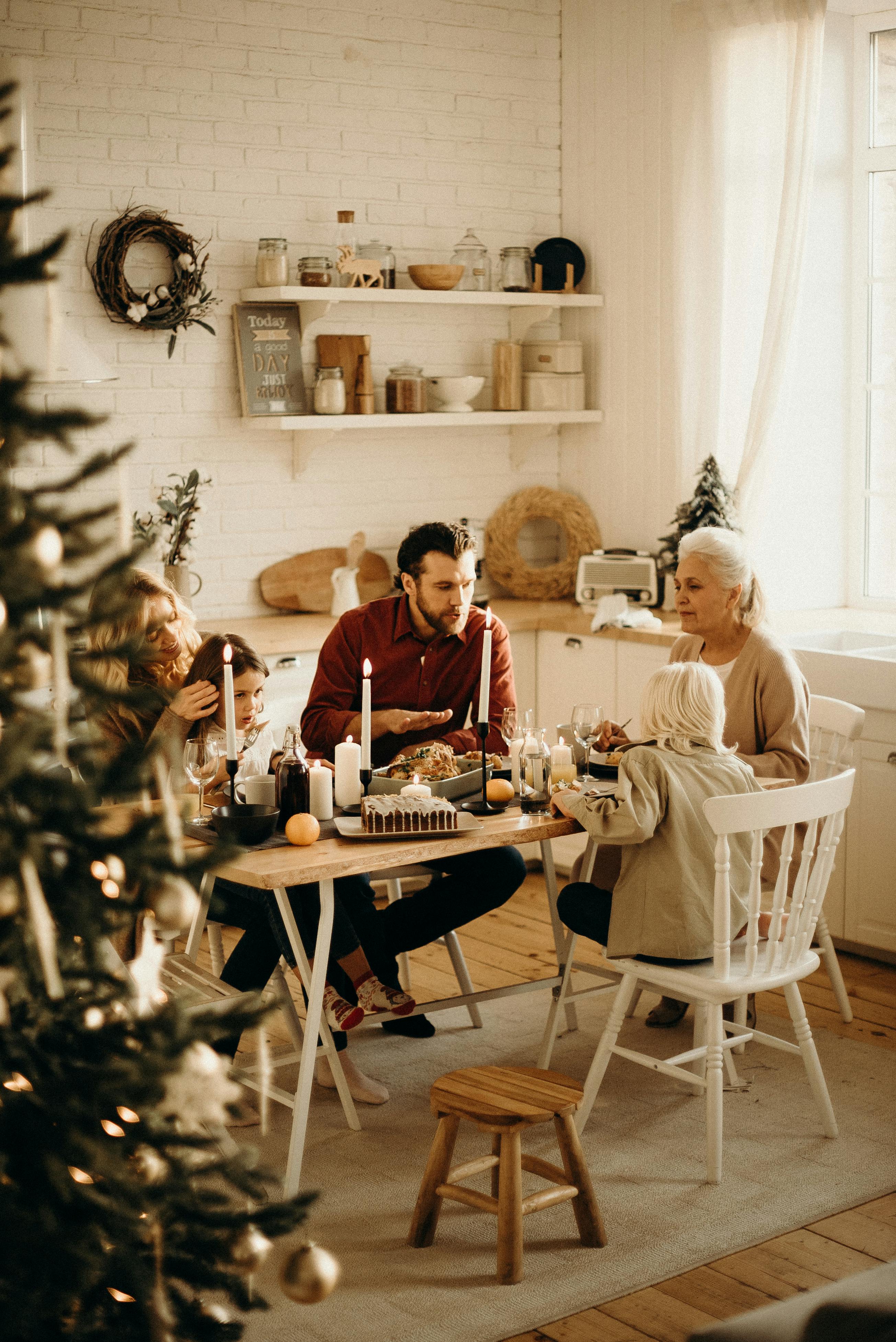 family sitting near dining table and eating food