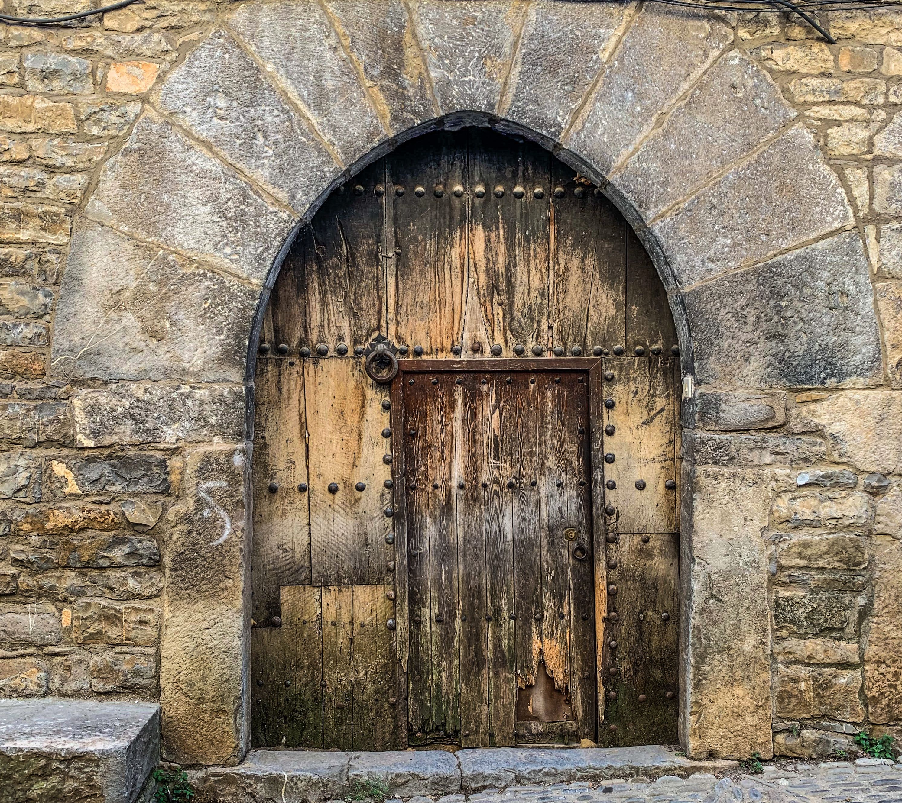 Rustic Medieval Wooden Door in Stone Wall · Free Stock Photo