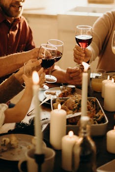 Warm family dinner scene with wine toasting and candlelight ambiance for a festive celebration.