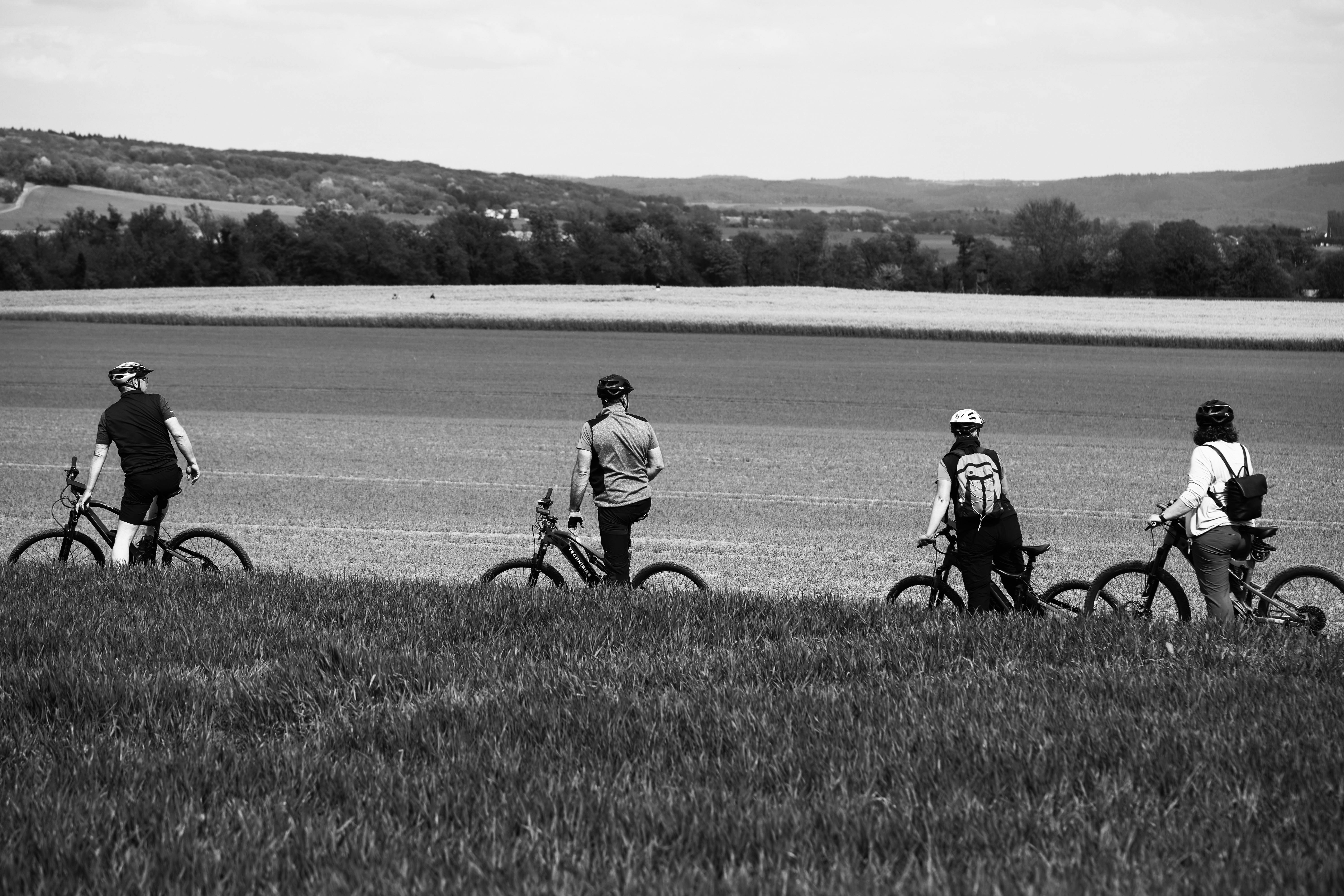 Group cycling through picturesque fields in Andernach, Germany.