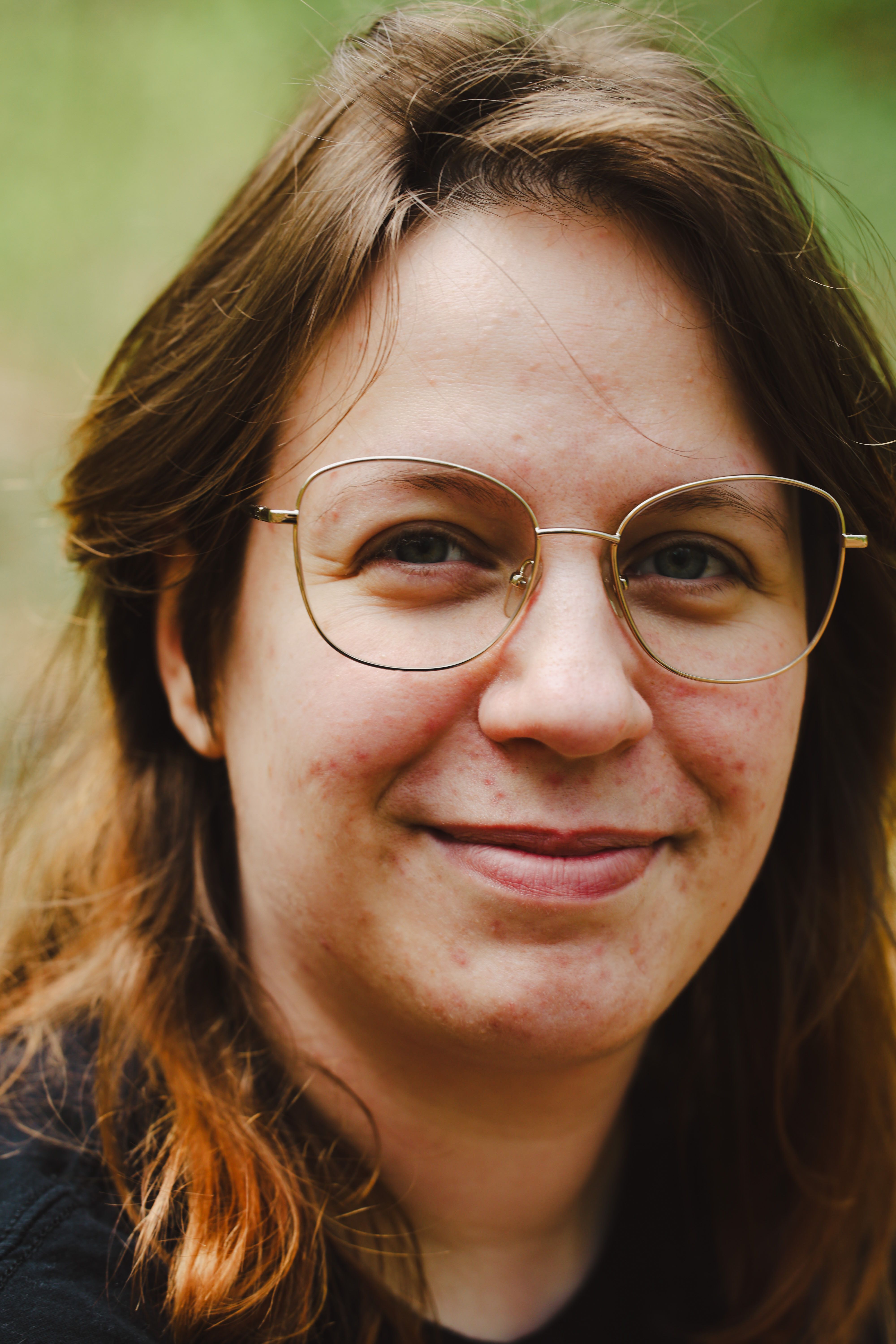 Close-up portrait of a smiling adult wearing glasses, photographed outdoors in Andernach.