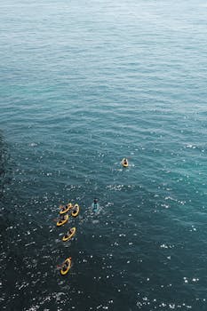Aerial view of kayakers enjoying the ocean at Carvoeiro, Portugal.