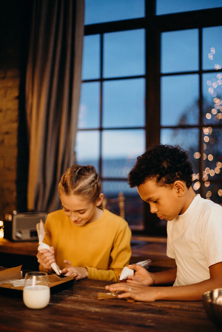 Girl And Boy Holding Icing Decor