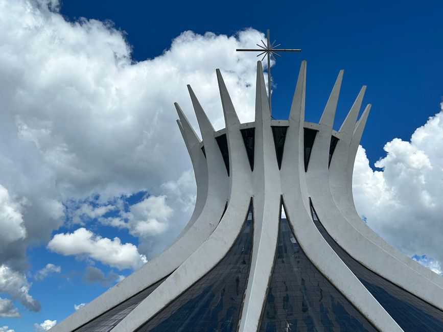 The iconic Brasília Cathedral with its striking modernist design against a bright blue sky.