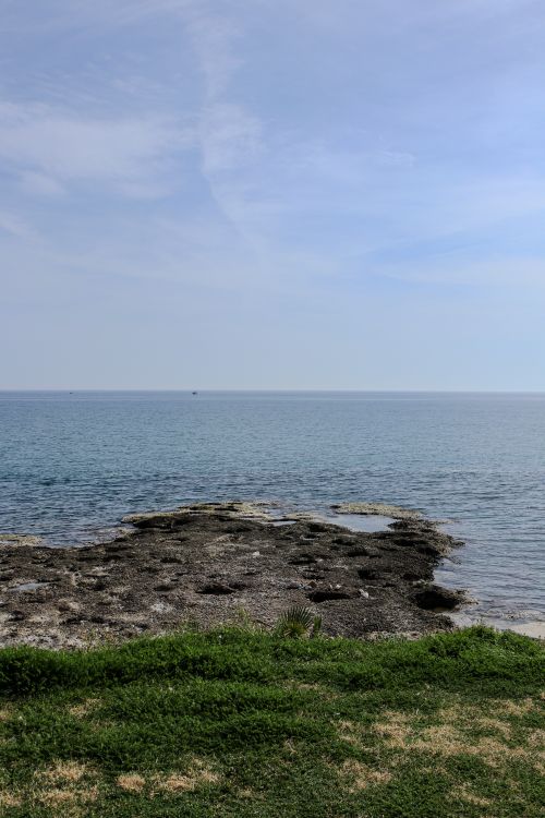 Free Peaceful seaside view in Antalya, Turkey showcasing calm waters and natural coastline beauty. Stock Photo