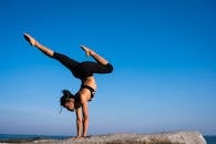 Woman With Arms Outstretched Against Blue Sky