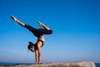 Woman With Arms Outstretched Against Blue Sky