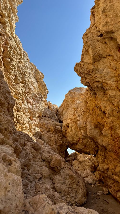 Free Experience the striking rock formations and clear sky of an Omani canyon. Stock Photo