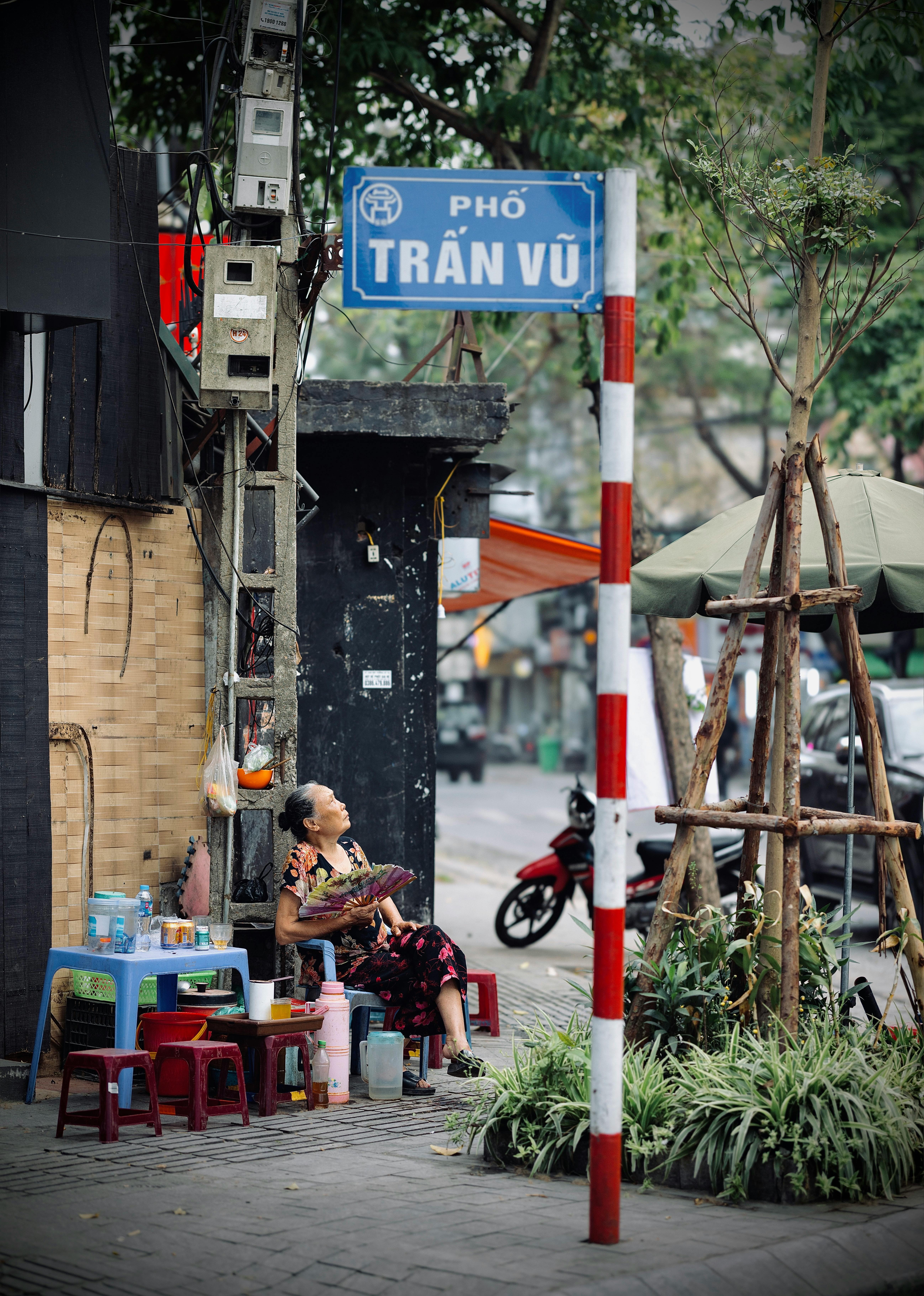 Local vendor seated at Trấn Vũ street in Hanoi, Vietnam.