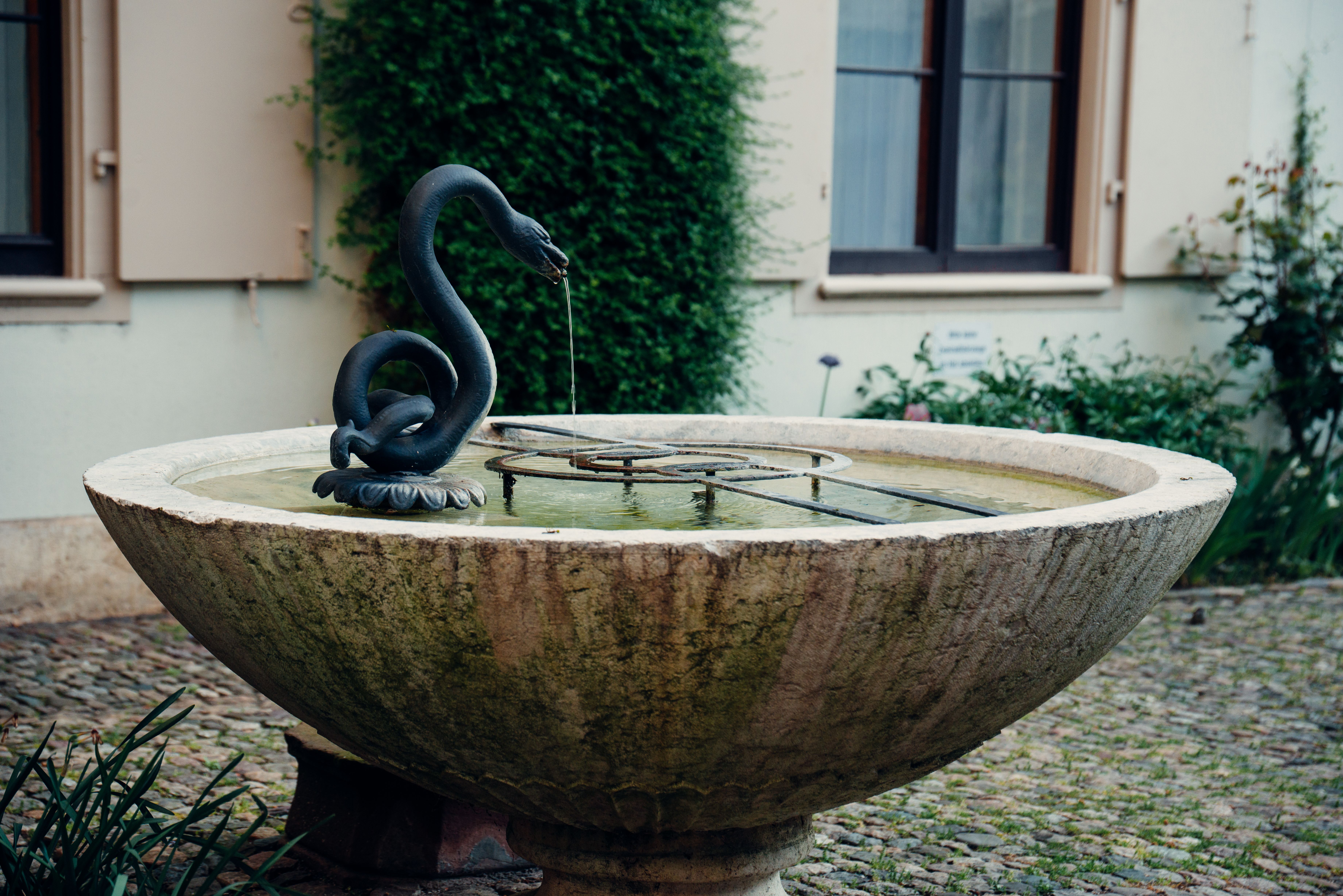 Outdoor stone fountain with water feature in a courtyard garden setting