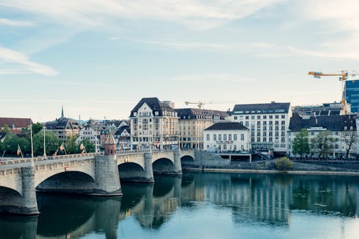 Scenic view of Basel city along the Rhine River showcasing architectural beauty and reflections.