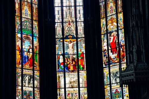 Free Vibrant stained glass windows depicting religious scenes in a Basel church, capturing stunning details and colors. Stock Photo