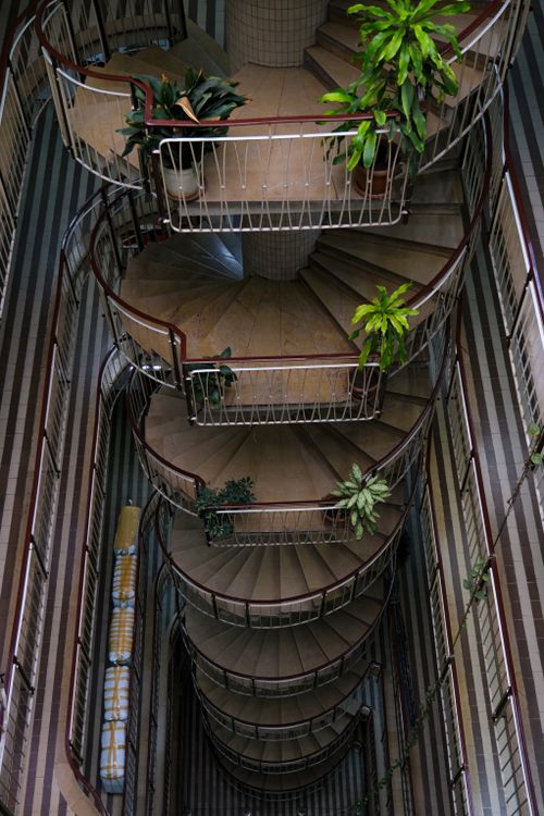 Free A stunning view of an intricate spiral staircase adorned with lush indoor plants in an İstanbul building. Stock Photo
