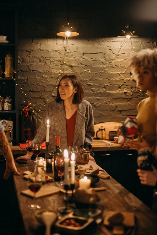 Two Women Standing Beside Table With Lighted Candles